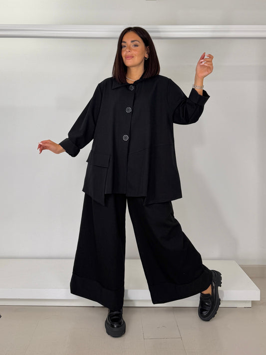 Pantalone gamba larga con bordo